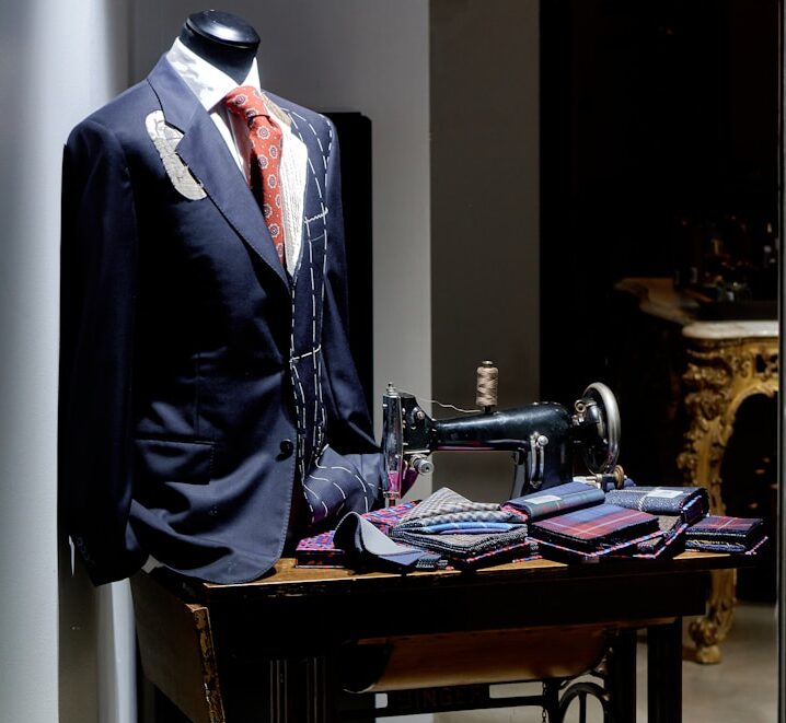black suit jacket on black and brown sewing machine
