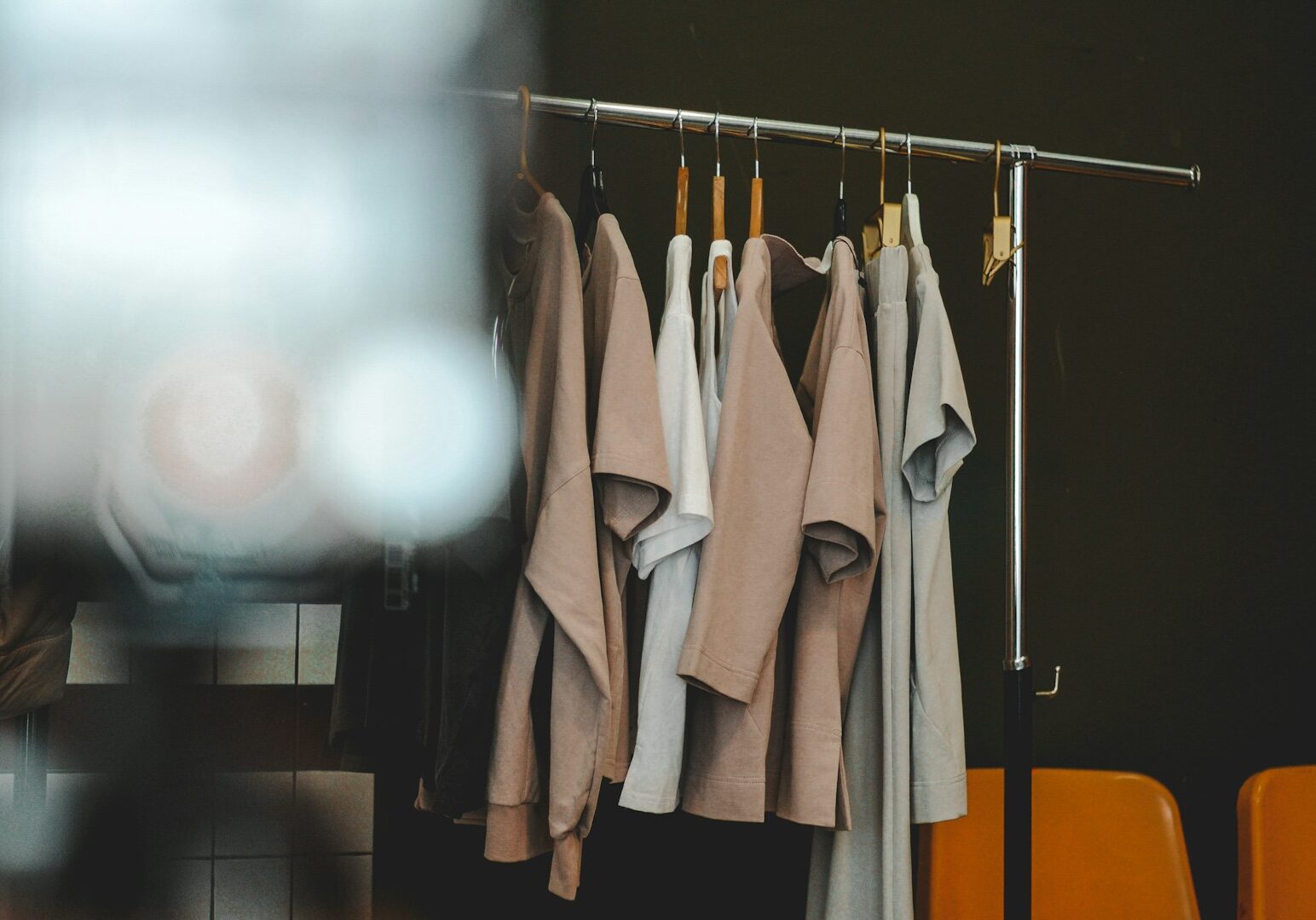 Clothes hang on a rack in a minimalist style.